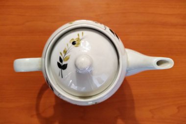 Kettle on table wooden background