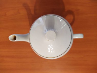 Kettle on table wooden background