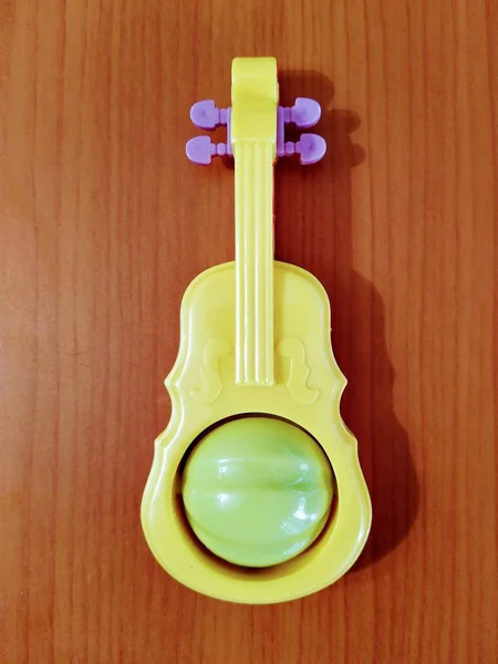 Toy guitar beanbag on wooden background — Stok fotoğraf