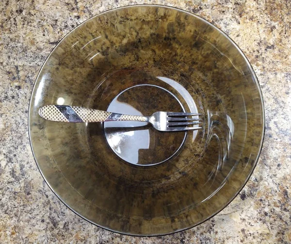 Bowl with fork on kitchen table background — Stockfoto