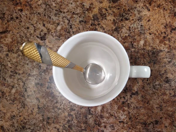 Tasse mit Teelöffel auf Küchentisch Hintergrund — Stockfoto