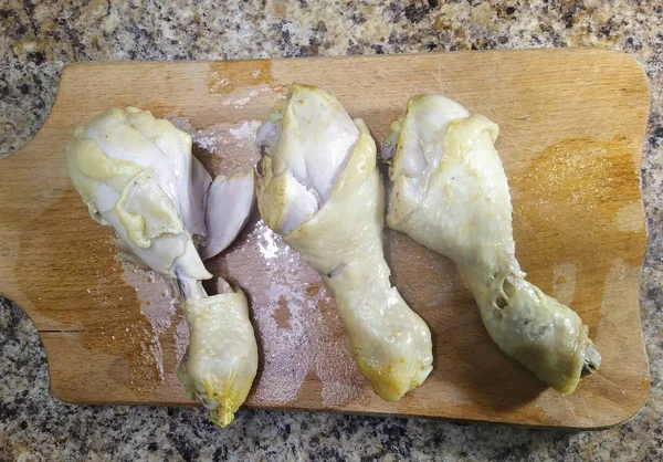 キッチンテーブルの上でまな板の上で鶏の足を調理 — ストック写真