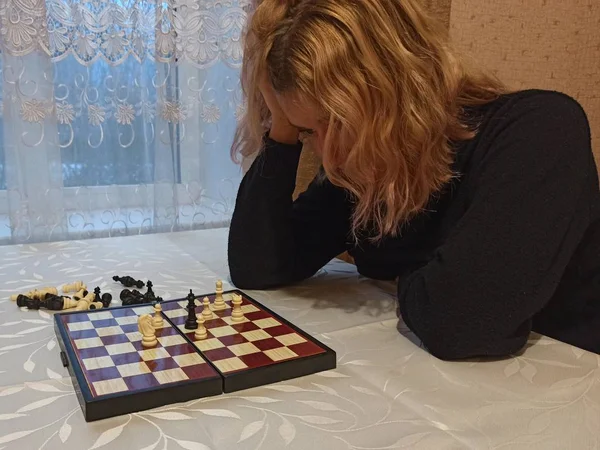全神贯注的欧洲姑娘在桌边下棋 — 图库照片