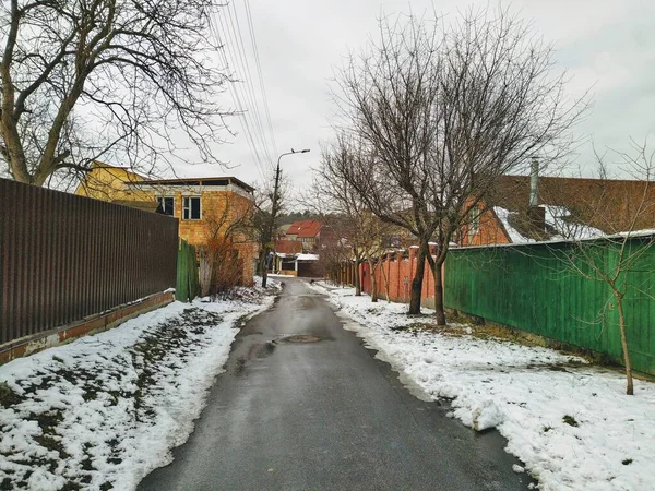 Suburbia district street and houses at winter season