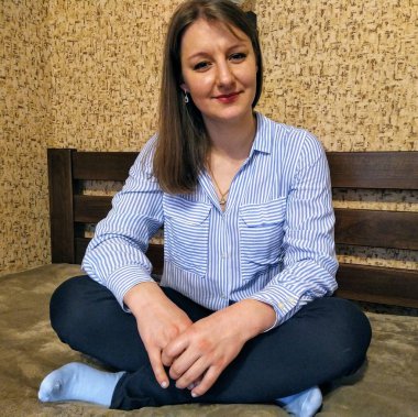 Yüzünde şüphe ifadesi olan Avrupalı bir kadın yatak odasında evde oturuyor.