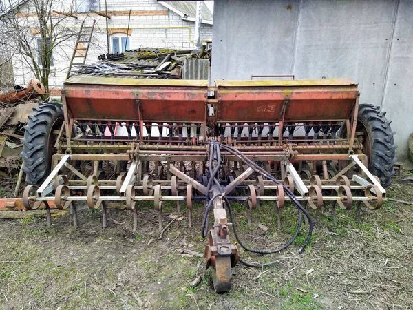 Agricultural machinery on farm yard in rural countryside at spring season