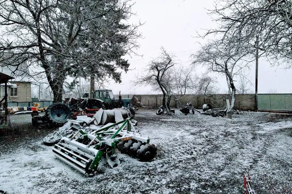 Agricultural machinery on farm yard in rural countryside at winter season