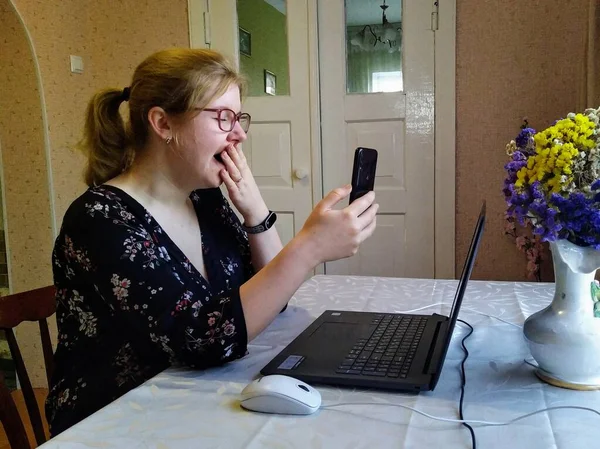 Yawning European Young Woman Sit Table Have Video Call Smartphone — Stock Photo, Image