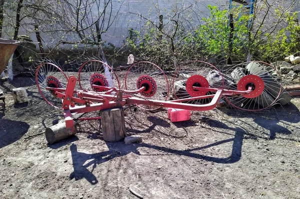 Agricultural machinery on farm yard in rural countryside at spring season