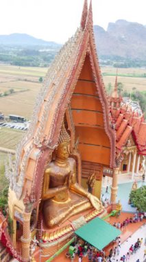 Time lapse of people worships Buddha statue at Tiger Cave Temple (Wat Tham Sua) in Kanchanaburi, Thailand
