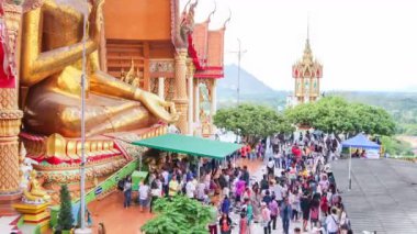 Time lapse of people worships Buddha statue at Tiger Cave Temple (Wat Tham Sua) in Kanchanaburi, Thailand