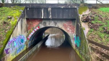 Germany - Hude 23, february, 2020:A tunnel under some rails is flooded with heavy rain