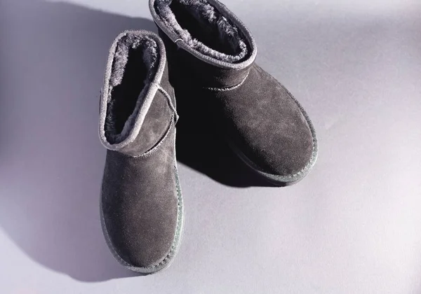 Black suede uggs. Stock photo on a black background.