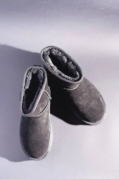 Black suede uggs. Stock photo on a black background.