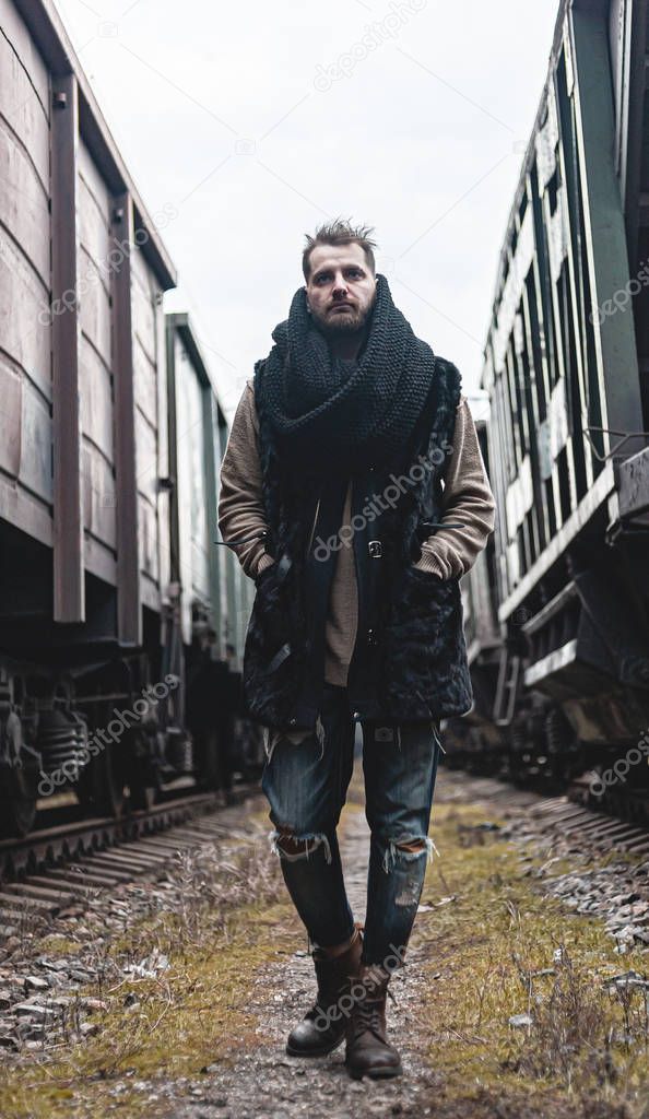 Portrait of a man in the middle of trains.