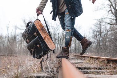 Demiryolunda süet sonbahar botları giyen bir adam. Yürüyüş, seyahat pratik kıyafetler, ayakkabılar..