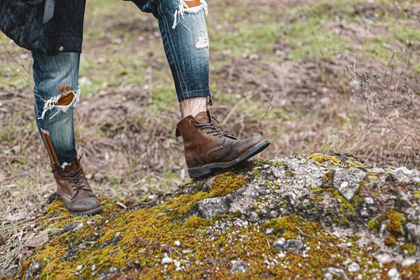 Guy hiking in comfortable hiking boots. Boots close-up stock photo.