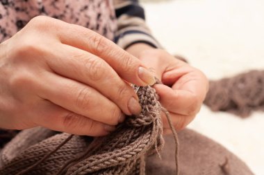 Yakından örgü örüyorum. Kadın eli kazak örer..