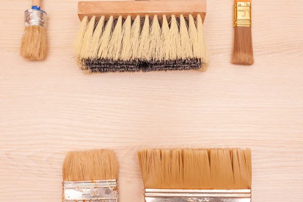 A large set of different construction brushes. Stock photo set of brushes for varnishing and primer, for different tasks. Empty space.