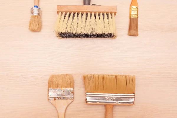 A large set of different construction brushes. Stock photo set of brushes for varnishing and primer, for different tasks. Empty space.