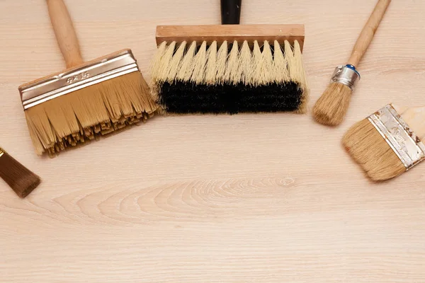 A large set of different construction brushes. Stock photo set of brushes for varnishing and primer, for different tasks. Empty space.