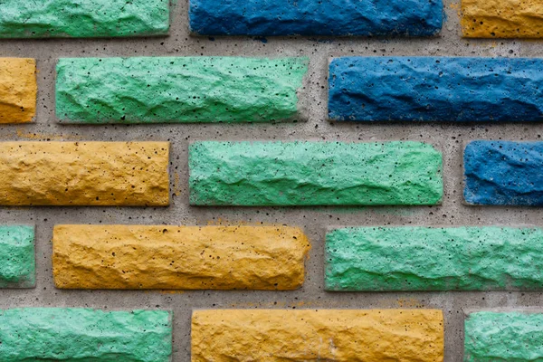 Decorative brick texture background. Stock photo multi-colored brick. Decorative brick poured out of forms.
