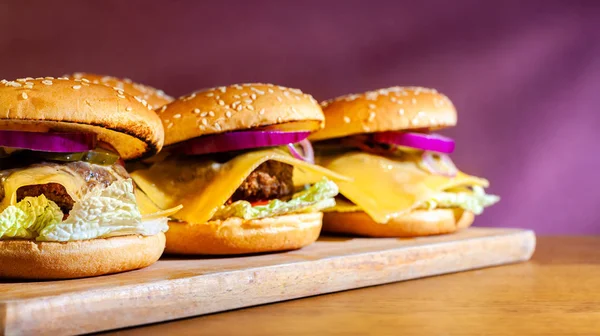 Vegetarian burger on a wooden board harvested in blank space. Stock photo vegan burger with plant foods.