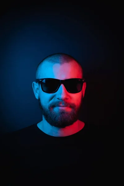 Brutal portrait neon style. Portrait of the face of a charismatic guy with a beard.