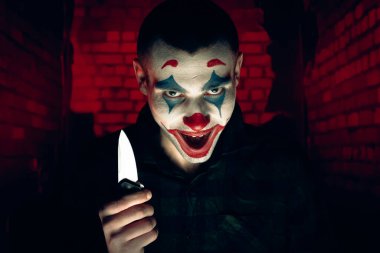 Şakacı bir adamın yakın plan portresi. Dehşet odasında makyaj malzemesi..