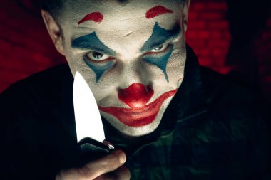 Şakacı bir adamın yakın plan portresi. Dehşet odasında makyaj malzemesi..