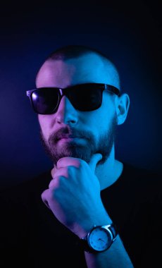 Renkli ışıklı bir hipster portresi. Stüdyoda hippi portresi.