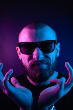 Renkli ışıklı bir hipster portresi. Stüdyoda hippi portresi.