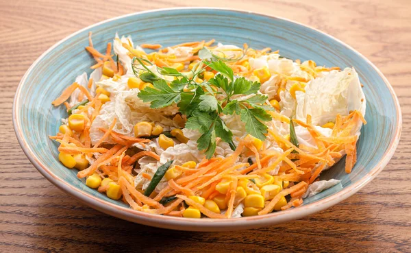 Vegetable salad with Chinese cabbage, carrots, corn, and parsley with green onions. Stock photo salad in a blue plate. — Stock Image Vegetable Salad Chinese Cabbage Carrots Corn Parsley Green Onions Stock Royalty Free Stock Photos