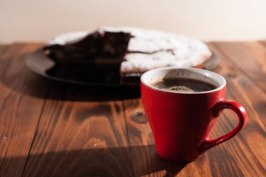 Tahta bir masada çikolatalı kahve ve pasta tatlısı..