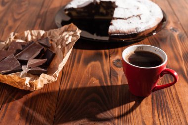 Tahta bir masada çikolatalı kahve ve pasta tatlısı..