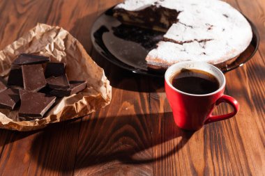 Tahta bir masada çikolatalı kahve ve pasta tatlısı..