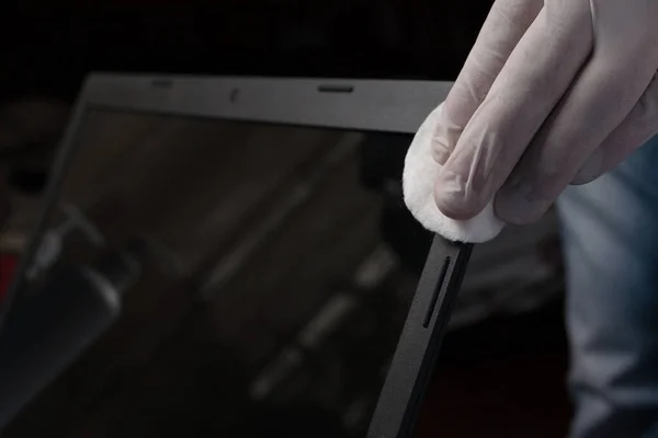 Close-up of disinfection cleaning a laptop in white gloves. Prevention of coronavirus infection.