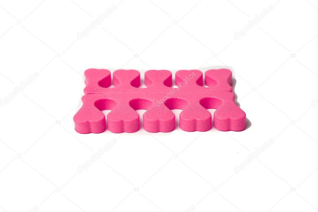 Toe separator isolated on a white background. Pair of toe separator in the form of small hearts. Spongy material.