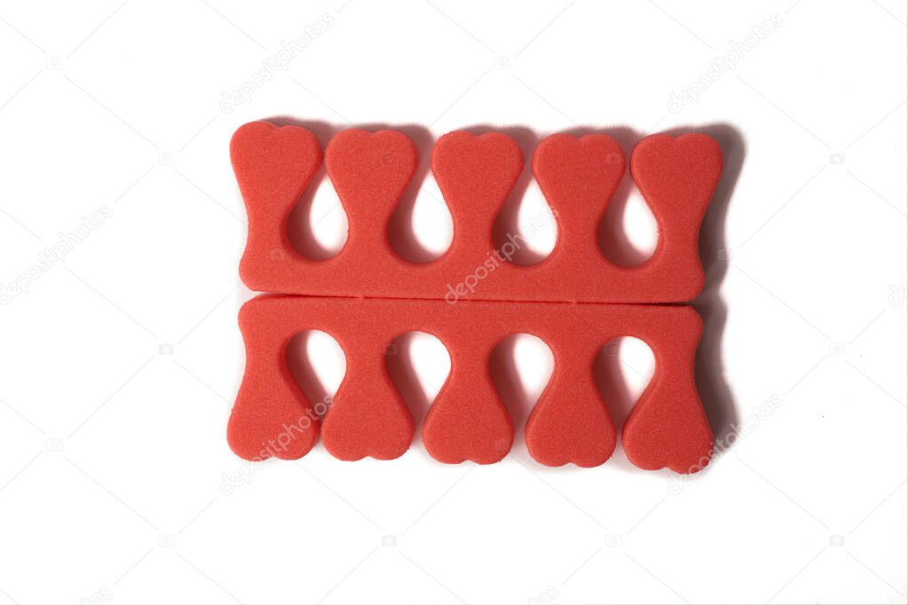 Toe separator isolated on a white background. Pair of toe separator in the form of small hearts. Spongy material.