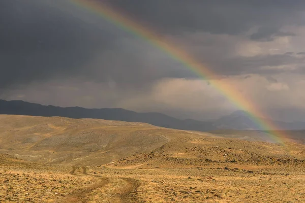 road steppe rainbow mountains storm