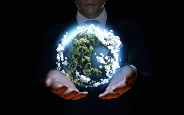 Businessman holding the world in the palm of hands. — Stock Photo, Image