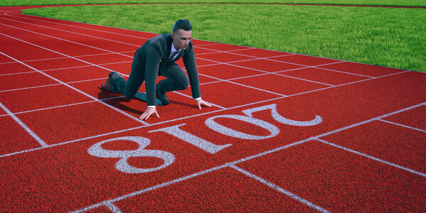 Businessman ready to sprint on starting line of the year 2018.