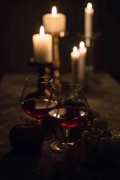 glasses of wine and candles on the table