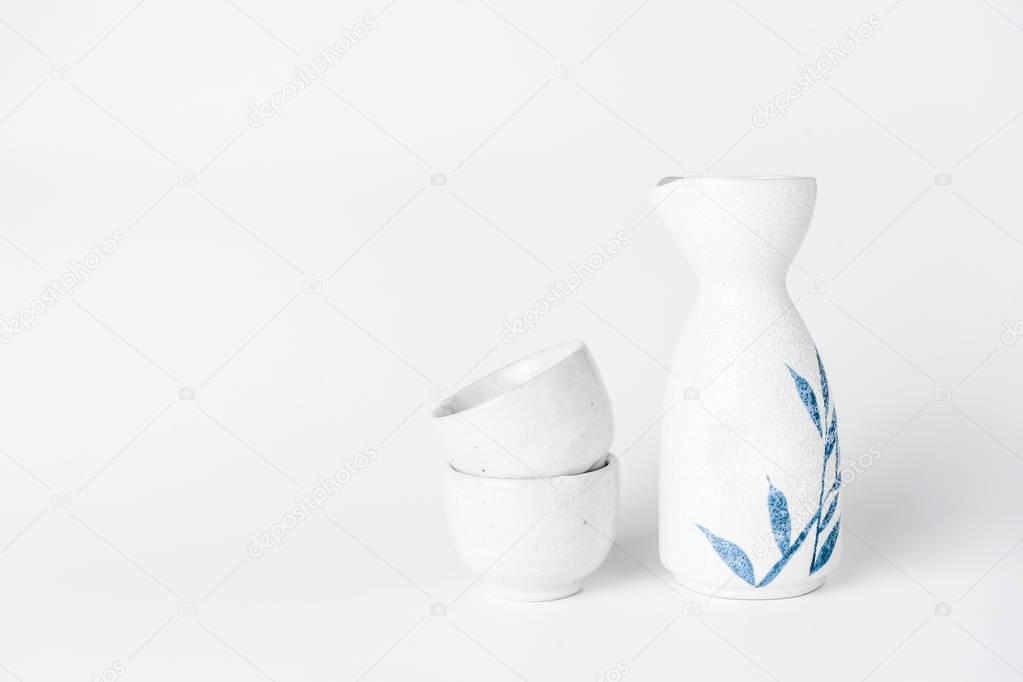 Close up of Japanese Sake drinking set on a white background.