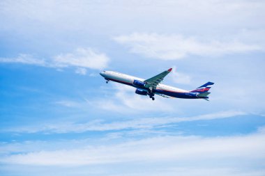 Phuket - Thailand - Otober 23,2017 :Aeroflot Airbus 330-300 airplane flying take off at Phuket airport over the Mai Khao beach in Thailand. clipart