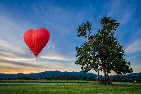 Beau ballon rouge en forme de coeur au coucher du soleil — Photo