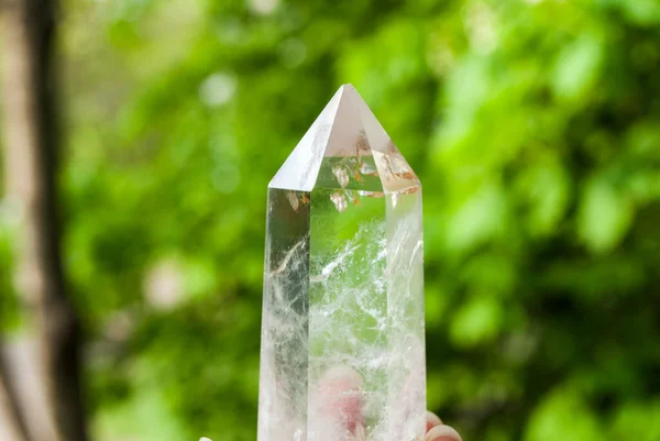 Quartz. Natural crystal without processing on a green background. Place for text