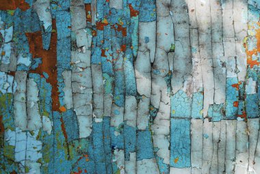 Çok katmanlı boyanın dokusu mavi kırmızı beyaz. Taşa benzeyen yaşlılıktan kalma doğal çatlaklar.