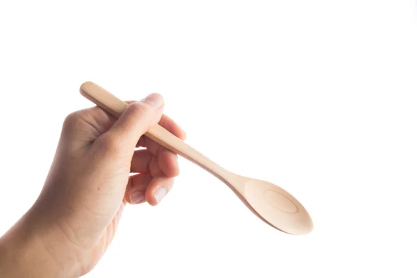 Woman hand taking wooden spoon — Stock Photo, Image