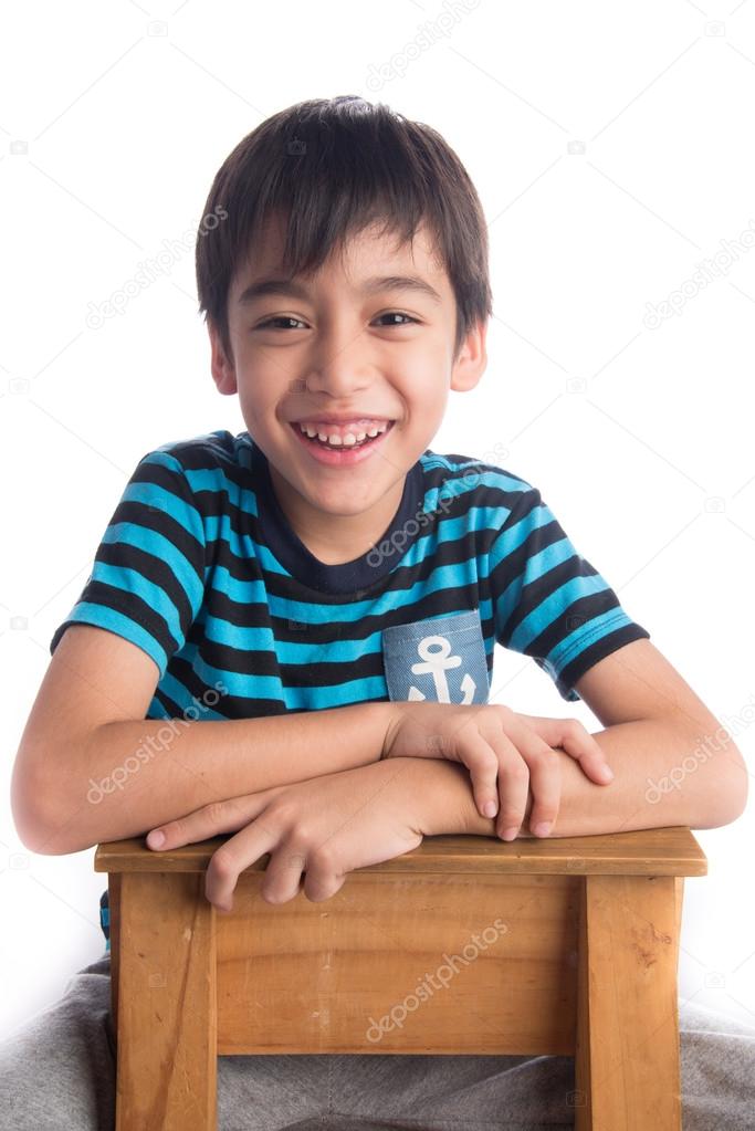 Little boy sitting on the wood chair on white background